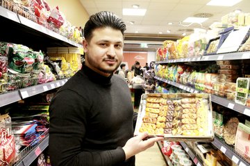 Marktzeit-Geschäftsführer Ahmad Nazari mit orientalischem Gebäck