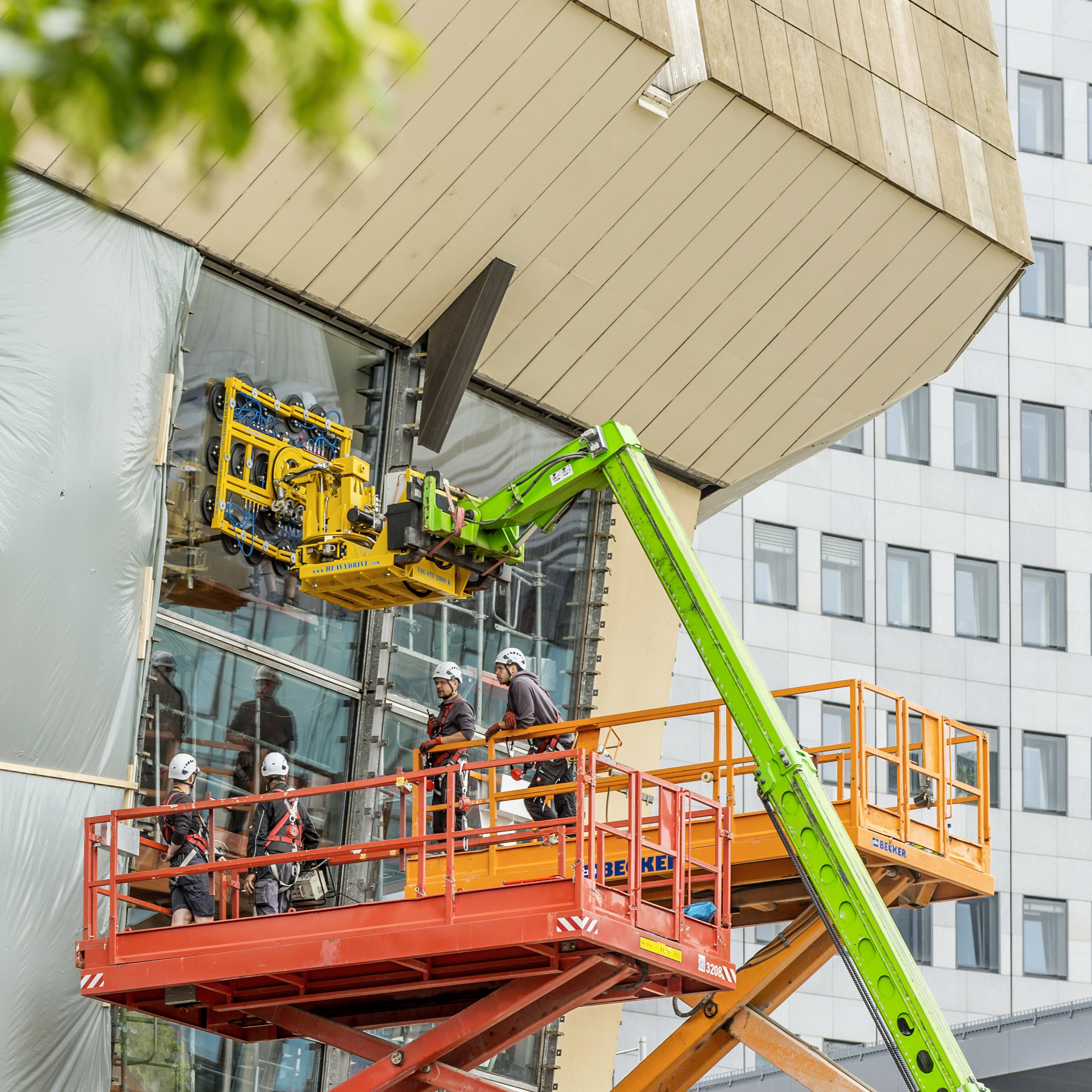 Arbeitende auf einem Kran an der Fassade des Gewandhauses 